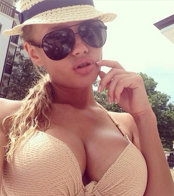 Olya Abramovich in a bikini taking a selfie