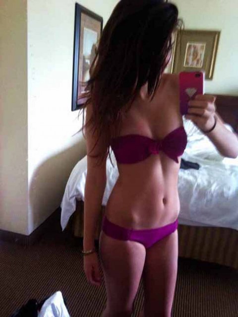 Selena Gomez in a bikini taking a selfie