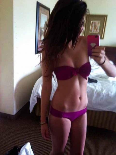 Selena Gomez in a bikini taking a selfie