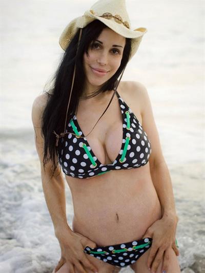 Nadya Suleman is better known as Octomom.  She was born Natalie Denise Suleman on July 11, 1975.  After 14 children she is stripping and making porn...

Octomom in a bikini and cowboy hat