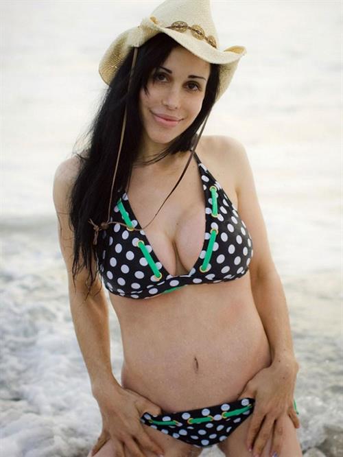 Nadya Suleman is better known as Octomom.  She was born Natalie Denise Suleman on July 11, 1975.  After 14 children she is stripping and making porn...

Octomom in a bikini and cowboy hat