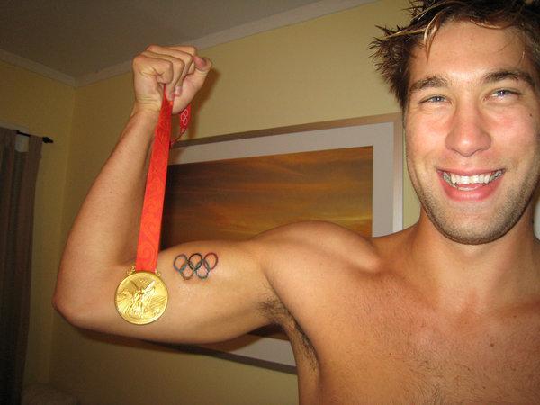 American Olympic Swimmer Matt Grevers shows off his Gold Medal and his Olympic tattoo