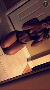 Tianna Gregory in a bikini taking a selfie