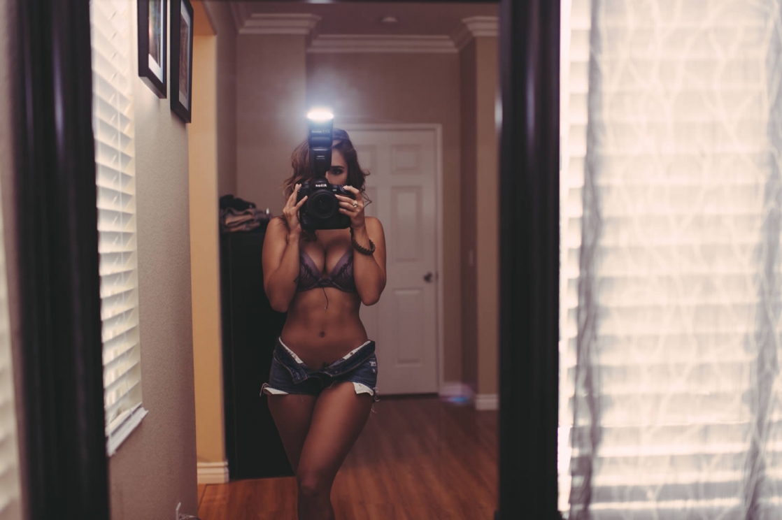 Tianna Gregory in a bikini taking a selfie