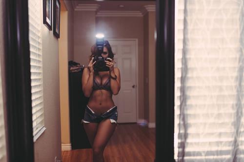 Tianna Gregory in a bikini taking a selfie