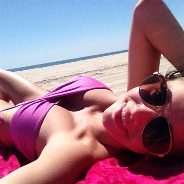 Caitlin Arnett in a bikini taking a selfie