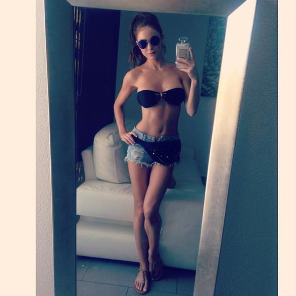 Laura Carter in a bikini taking a selfie
