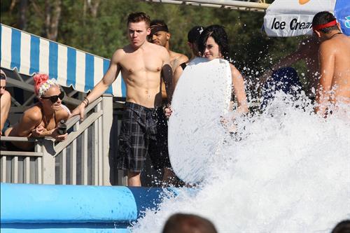 Katy Perry talks with a group of her friends after spending the afternoon at Raging Waters in San Dimas, California on August 12, 2012