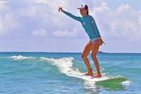 Alessandra Ambrosio surfing and eating a sno cone in Hawaii on October 12, 2011 