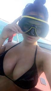 Demi Rose Mawby in a bikini taking a selfie