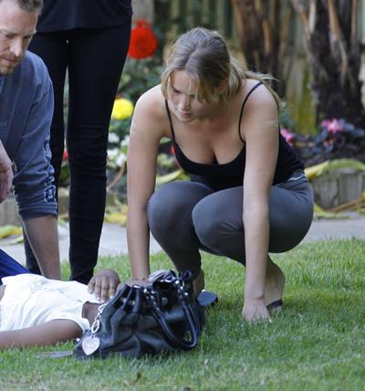 Jennifer Lawrence in Santa Monica helping a woman who fainted on June 25, 2012 
