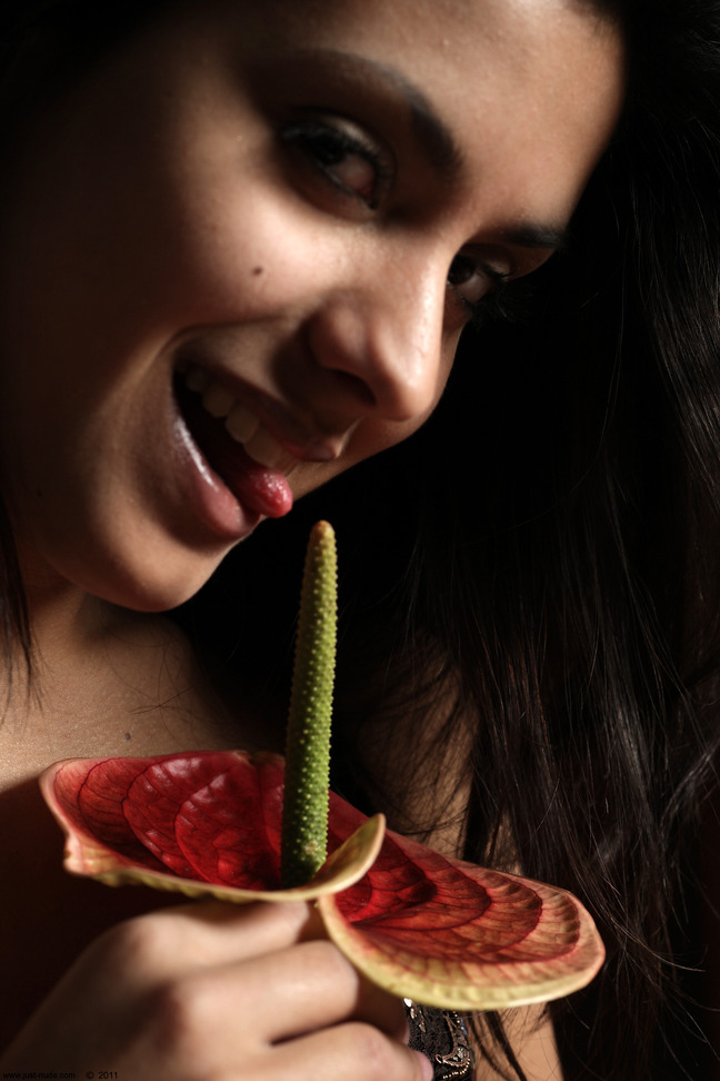 Belinda A nude poses with a flower