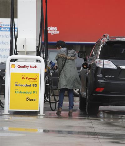 Dannii Minogue - Pictured getting a little wet while filling up on petrol - 09th August 2012