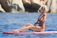 Victoria Silvstedt wearing a bikini on a board in Sardinia on August 8, 2012