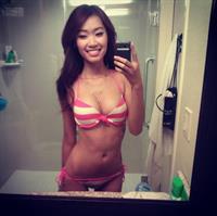 Elizabeth Tran in a bikini taking a selfie