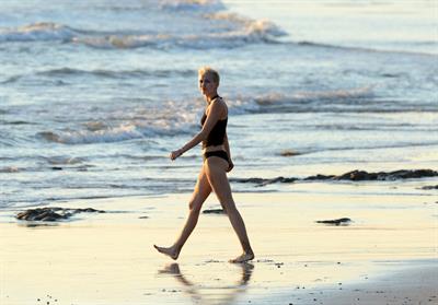Miley Cyrus  yoga in black bikini on beach in Hawaii 1/24/13 