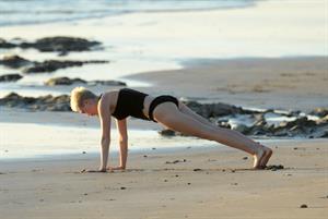 Miley Cyrus  yoga in black bikini on beach in Hawaii 1/24/13 