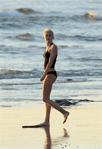 Miley Cyrus  yoga in black bikini on beach in Hawaii 1/24/13 