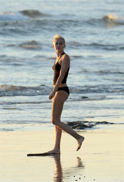 Miley Cyrus  yoga in black bikini on beach in Hawaii 1/24/13 