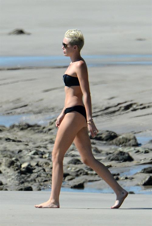 Miley Cyrus  yoga in black bikini on beach in Hawaii 1/24/13 