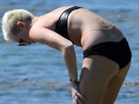 Miley Cyrus  yoga in black bikini on beach in Hawaii 1/24/13 