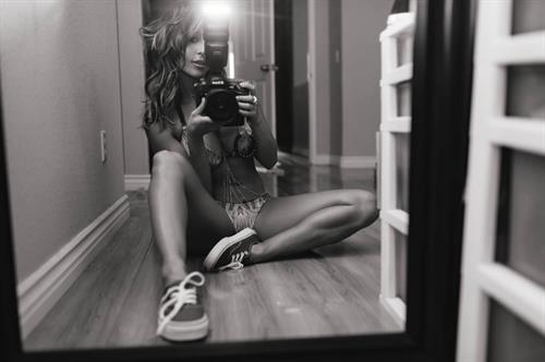 Tianna Gregory in a bikini taking a selfie