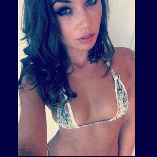 Nicole Mejia in a bikini taking a selfie