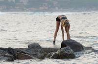 Kimberley Garner in a black bikini on the beach in St. Tropez on July 31, 2014