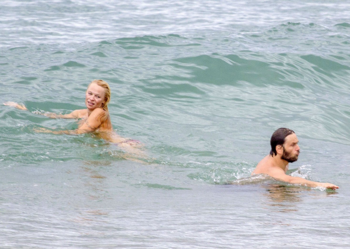 Pamela Anderson Pamela Anderson Going topless at the beach in France 02.10.13