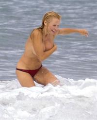 Pamela Anderson Pamela Anderson Going topless at the beach in France 02.10.13