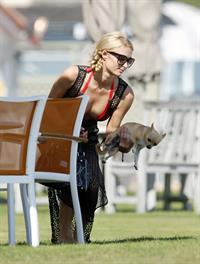 Paris Hilton at the beach in a skimpy red bikini and fishnet kaftan in Malibu.July 12, 2013