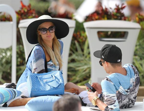 Paris Hilton spends the day in and out of the pool in Miami December 8, 2012