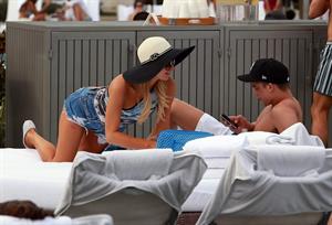 Paris Hilton spends the day in and out of the pool in Miami December 8, 2012