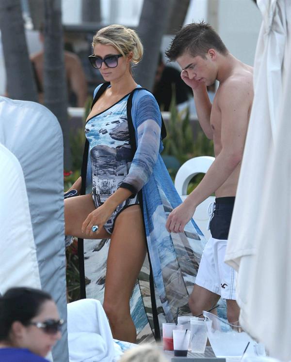 Paris Hilton spends the day in and out of the pool in Miami December 8, 2012