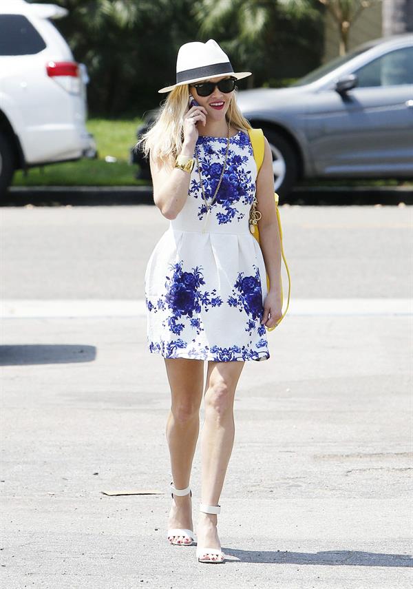 Reese Witherspoon talking and walking after leaving a hair salon in Beverly Hills on August 8, 2014