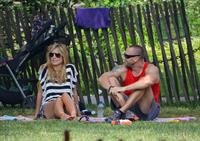 Heidi Klum in a black and white striped shirt, spends a day out in a park in Tribeca on June 30, 2013 