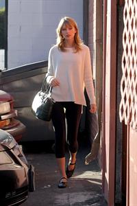 Taylor Swift wearing a white top and black pants in Los Angeles 10/28/13  
