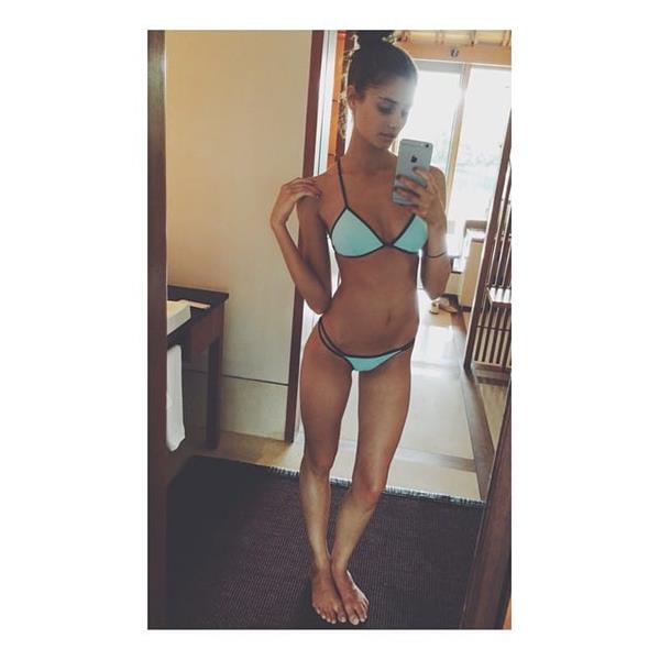 Taylor Marie Hill in a bikini taking a selfie