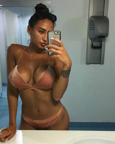 Astrid Nelsia in a bikini taking a selfie
