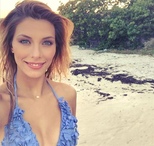 Camille Cerf in a bikini taking a selfie