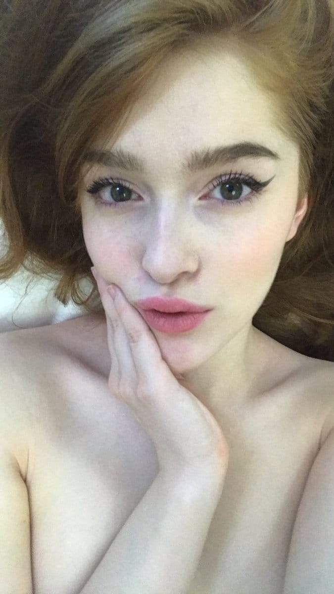 Jia Lissa in black lingerie on bed showing her pussy