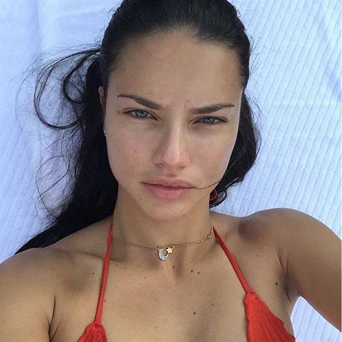 Adriana Lima in a bikini taking a selfie