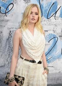 Ellie Bamber braless boobs while wearing basically a scarf as a top showing side boob cleavage.








