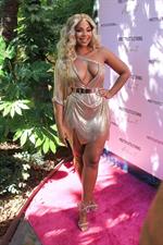 Ashanti sexy cleavage in a low cut dress at the PrettyLittleThings launch party.

