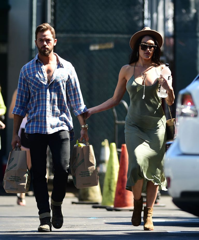 Nikki Bella Pictures Nikki Bella braless boobs in a green dress seen by paparazzi.