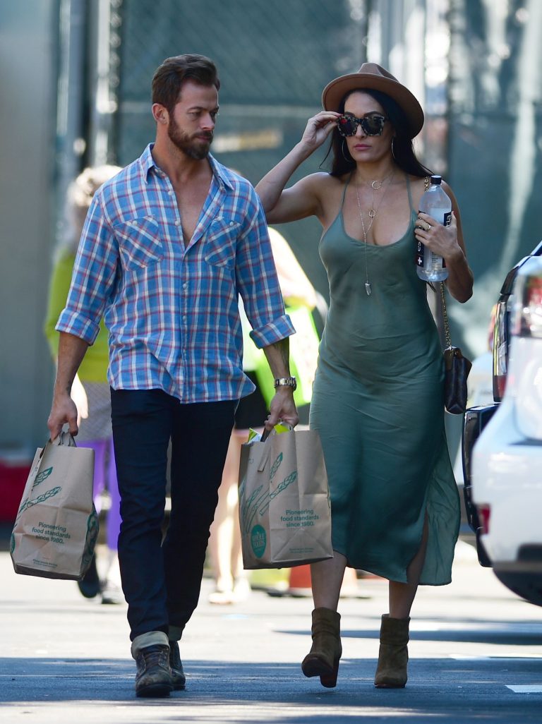 Nikki Bella Pictures Nikki Bella braless boobs in a green dress seen by paparazzi.