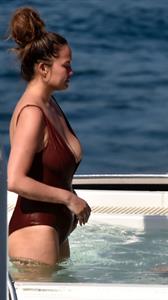 Chrissy Teigen sexy cleavage and ass in a swimsuit with her husband John Legend seen by paparazzi.
