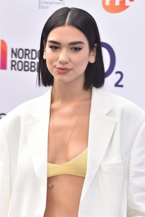 Dua Lipa looking hot in a sexy revealing top seen by paparazzi.





