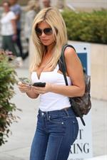 Donna D’Errico sexy boobs in a tight top showing nice cleavage seen by paparazzi.


