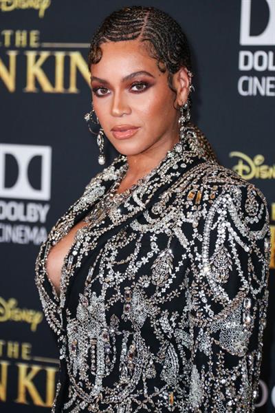 Beyonce braless boobs and areola peek showing off nice cleavage on the red carpet for the premiere of  The Lion King .






